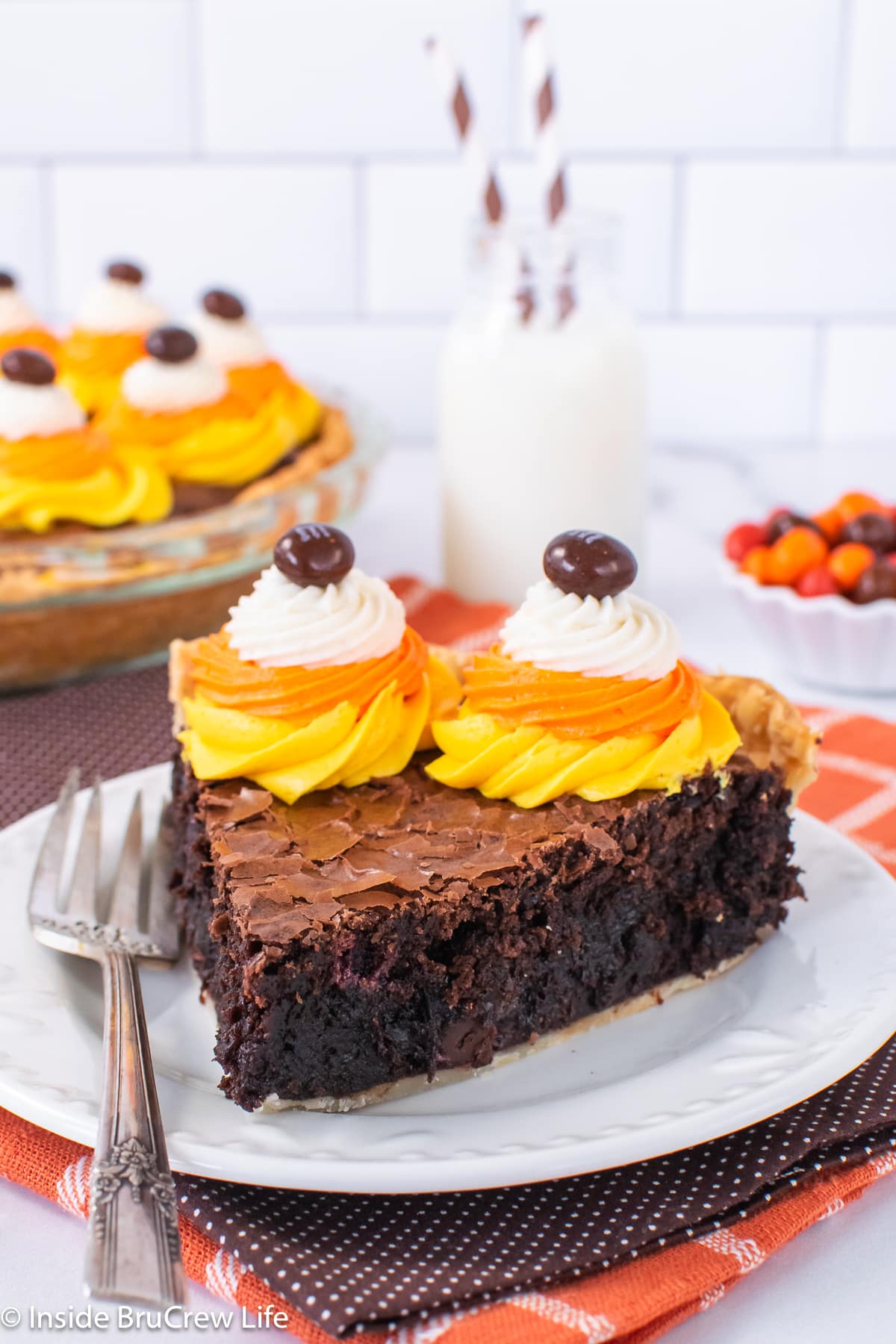 A white plate with a slice of Halloween pie on it.