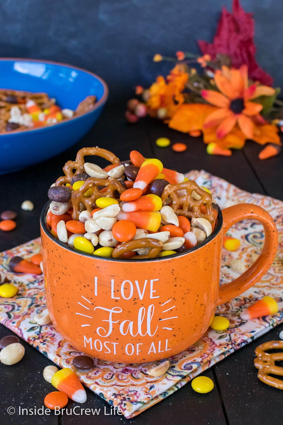 An orange cup filled with a fall trail mix.