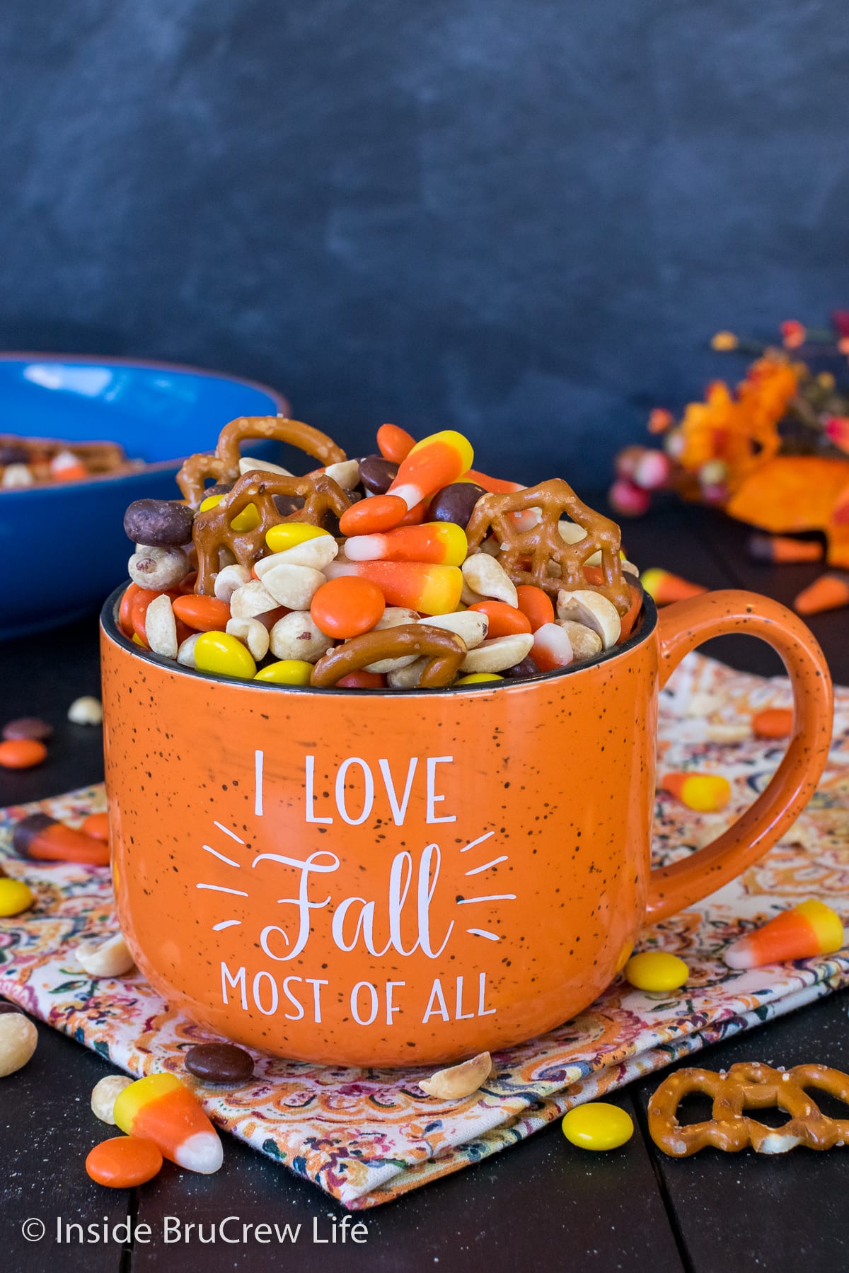 An orange cup filled with a fall trail mix.