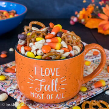 An orange cup filled with a fall trail mix.
