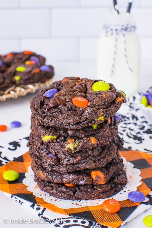 A stack of Halloween Chocolate Cookies and Cream Cookies on an orange napkin