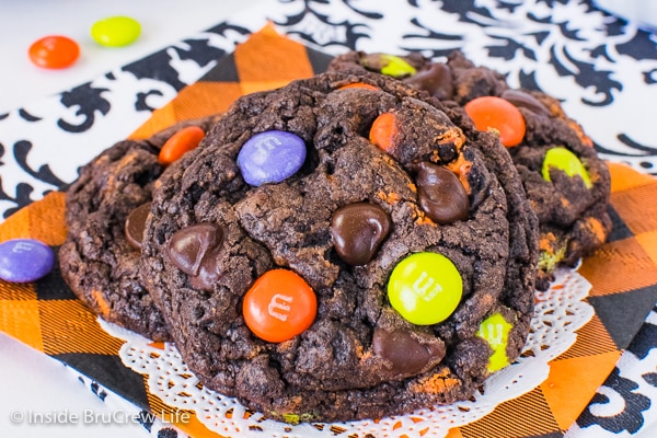 An orange napkin and doily with a few Halloween Chocolate Cookies and Cream Cookies on it