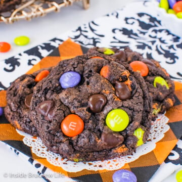 Three chocolate cookies and cream Halloween cookies on a white doily