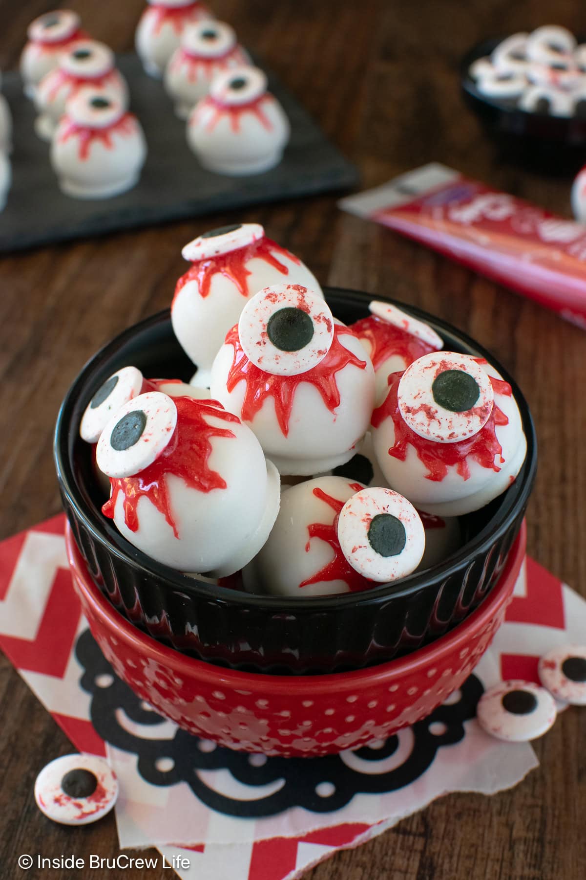 A bowl of zombie eyeballs on a table.