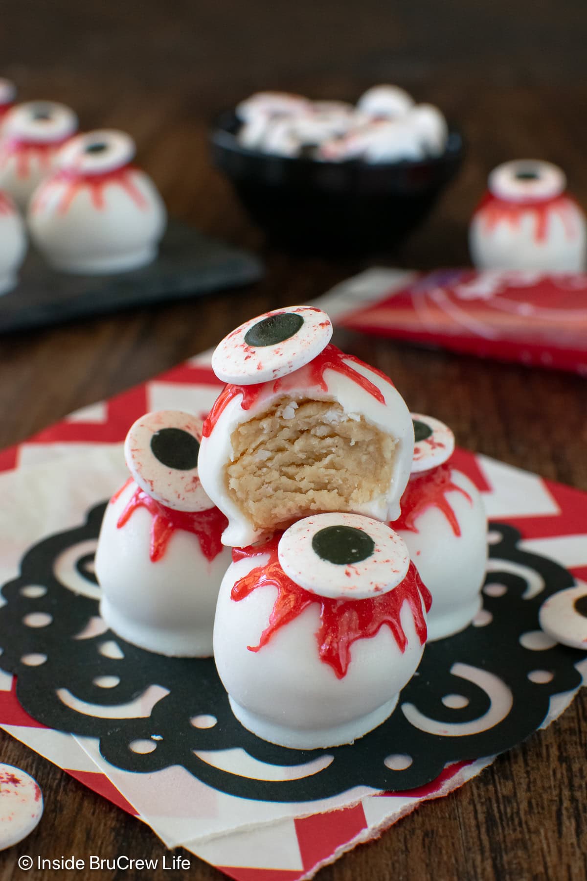 Peanut butter balls decorated like eyeballs on a table.