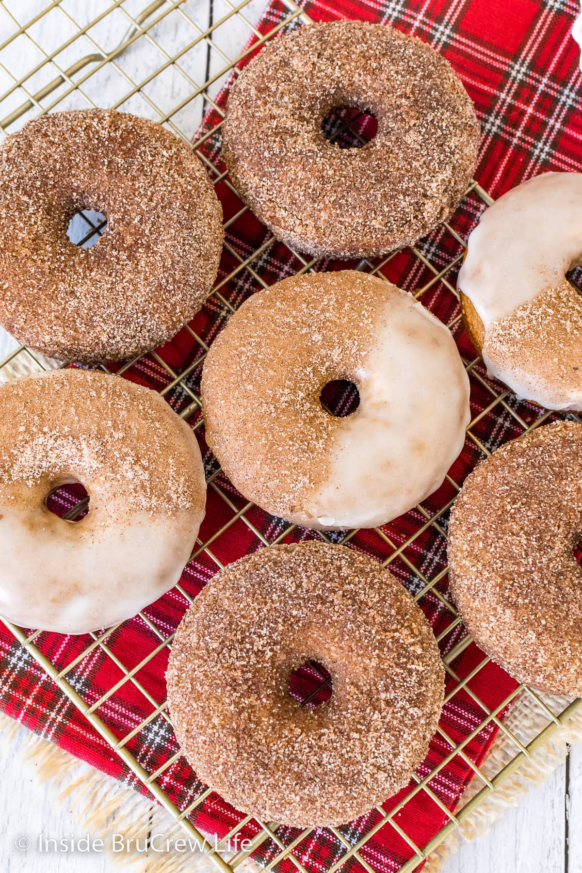 Cinnamon sugar coated donuts on a white board.