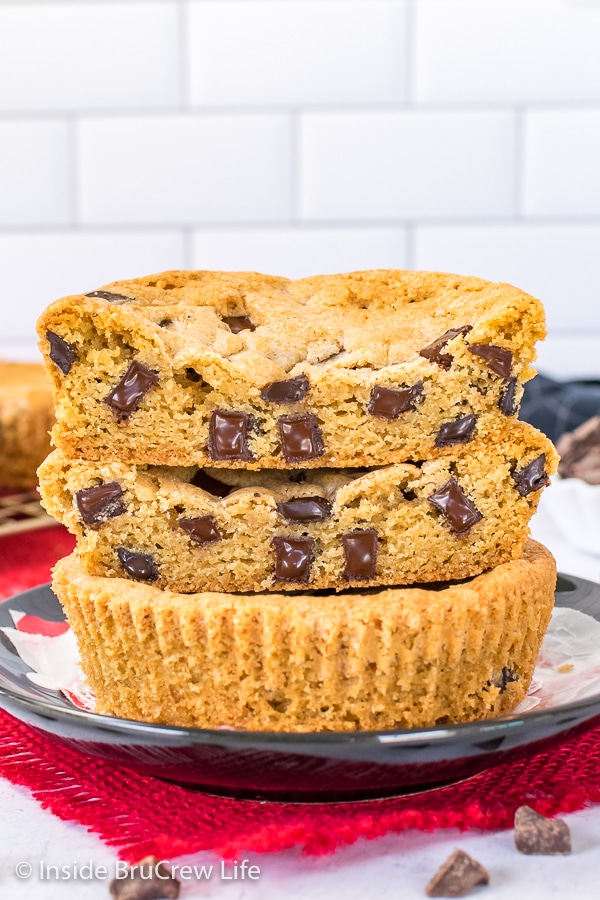 A deep dish chocolate chip cookie cut in half and stacked together showing the melty chunks.