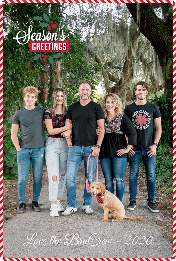 Family lined up on walkway with green trees behind them