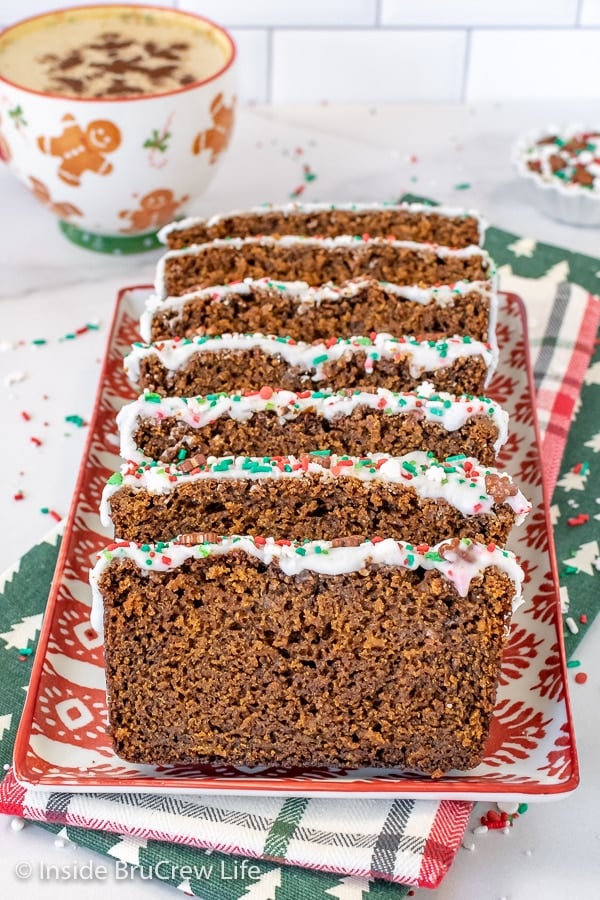 Slices of glazed gingerbread banana bread on a red and white plate.