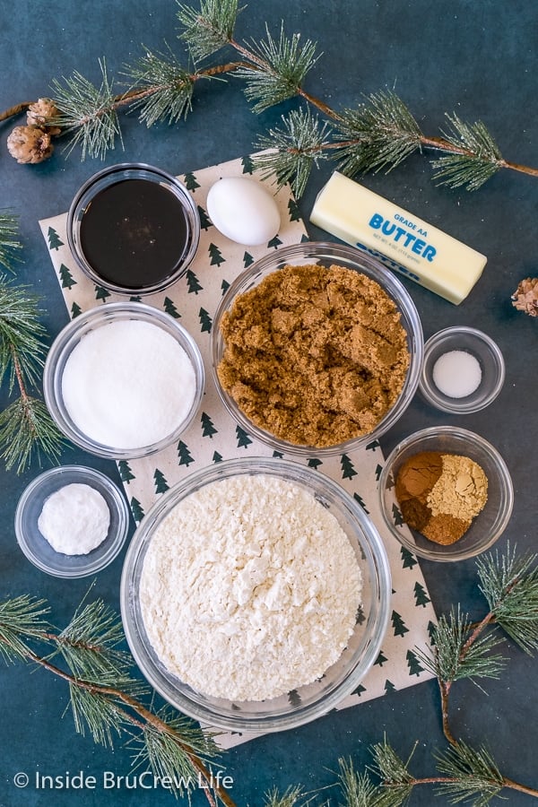 Overhead picture of the ingredients needed to make molasses crackle cookies on a blue background