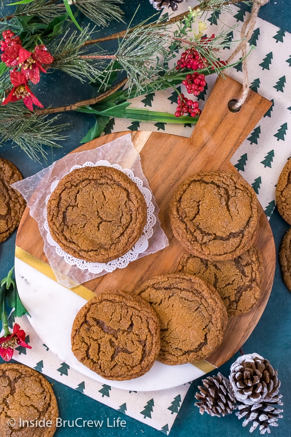 Overhead picture of molasses crackle cookies stacked on a round wood tray