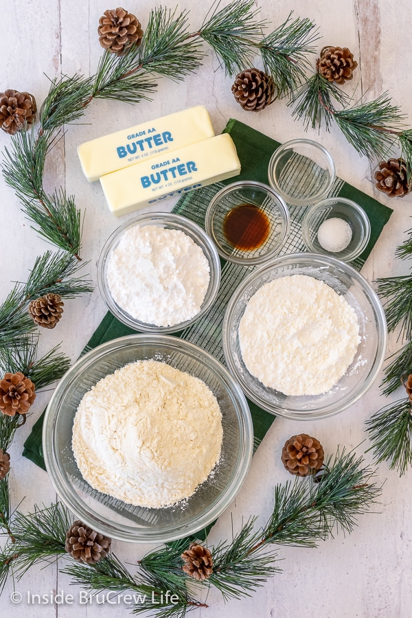 Bowls of ingredients needed to make cookies on a white board.