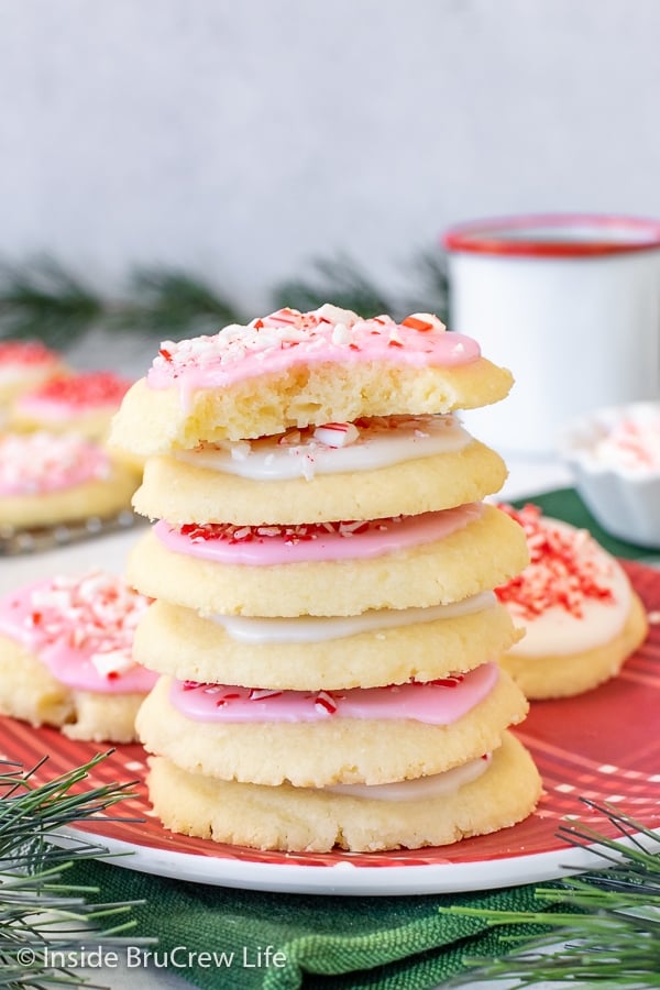 A red plate with a stack of peppermint meltaways topped with glaze and candies.