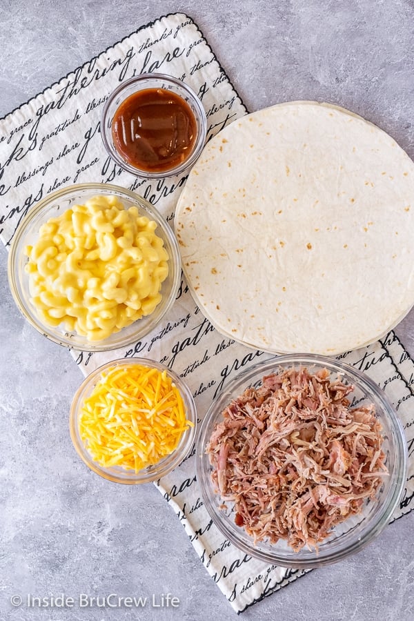 Overhead picture of all the ingredients needed to make a pulled pork macaroni and cheese tortilla wrap hack