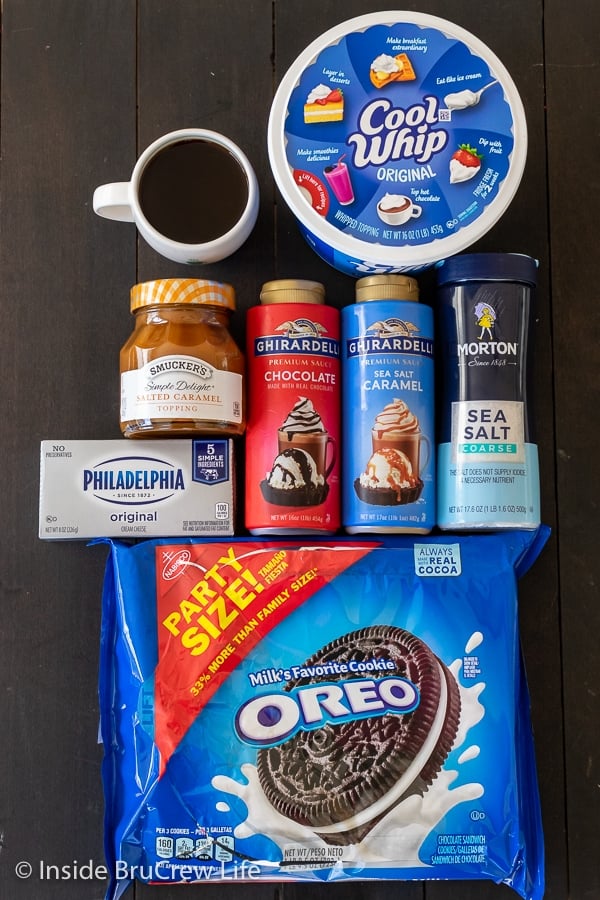 Overhead picture of the ingredients needed to make a Salted Caramel Oreo Icebox Cake on a dark board