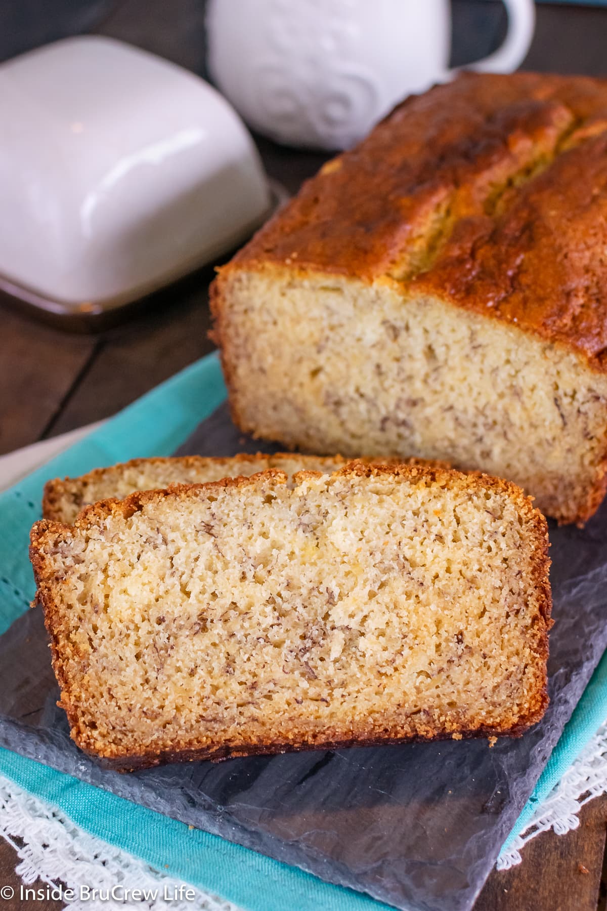 Slices of sweet bread on a dark tray.