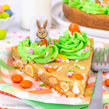 A slice of chocolate chip cookie cake decorated with green frosting and candies for Easter