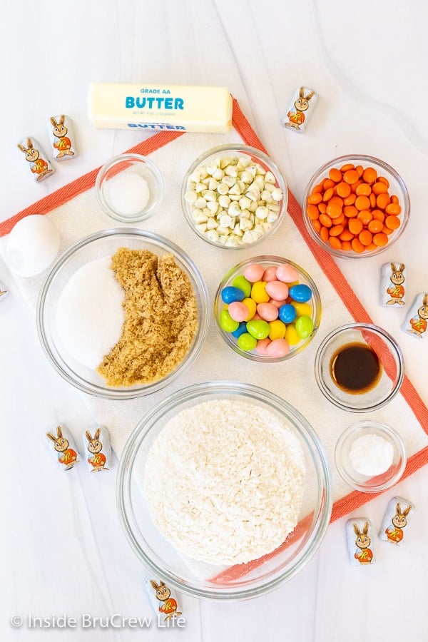 A white board with bowls of ingredients for a giant cookie cake.