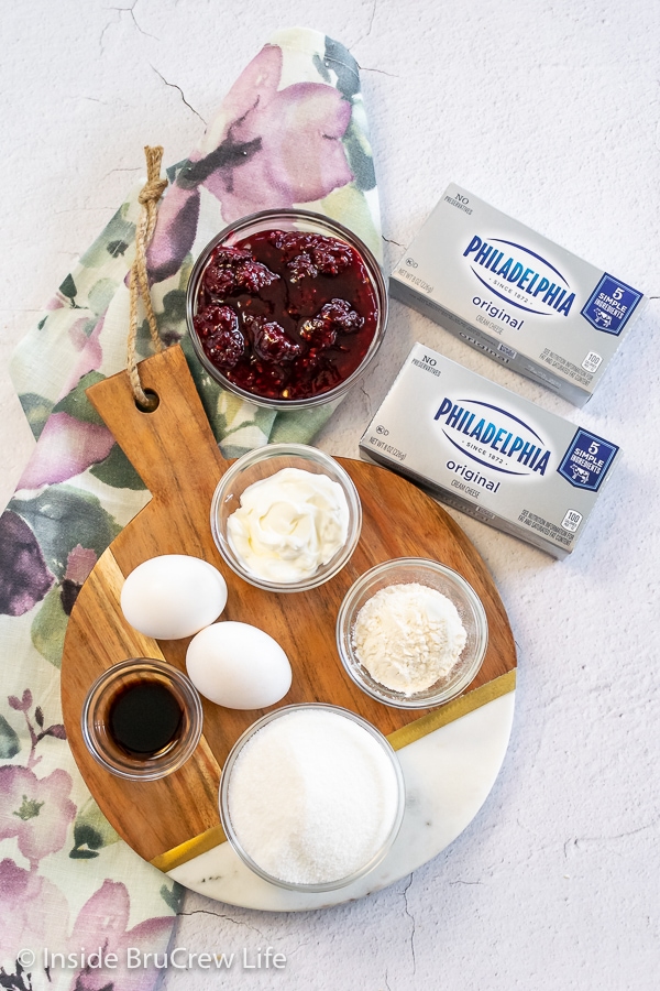 Bowls of ingredients needed to make a blackberry cheesecake pie