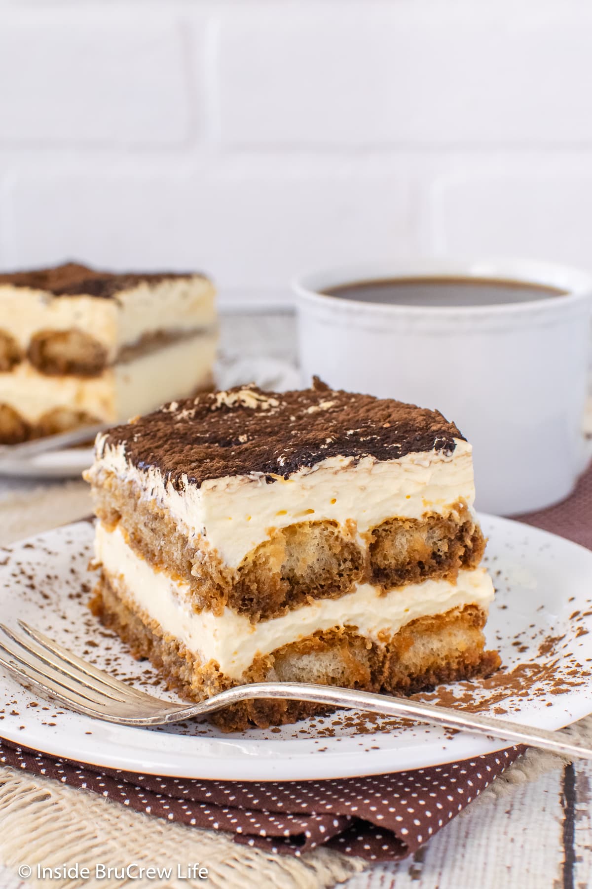 Two plates with squares of no bake coffee dessert on them.