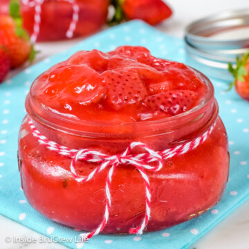 A small clear jar filled with strawberry pie filling.