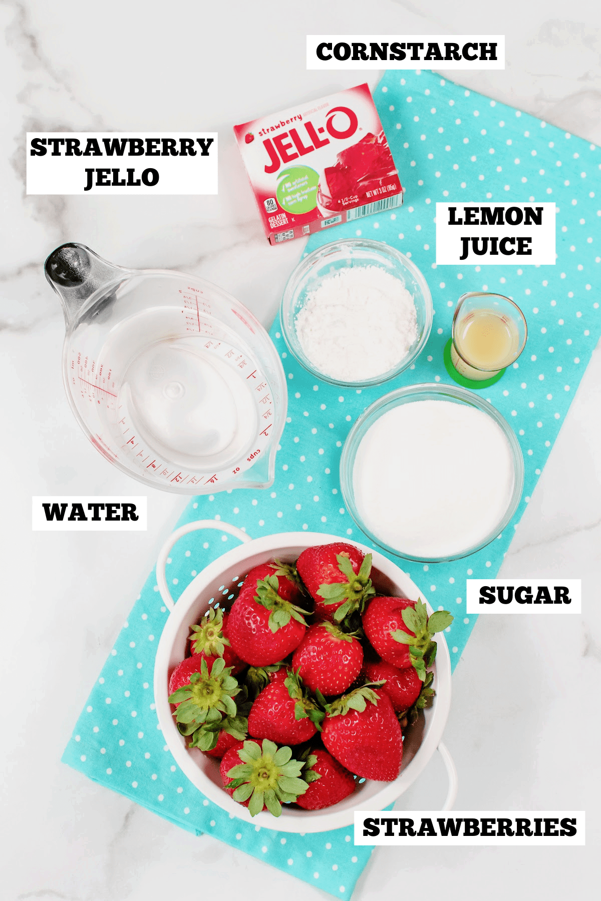 A white board with bowls of ingredients needed to make homemade pie filling with strawberries.