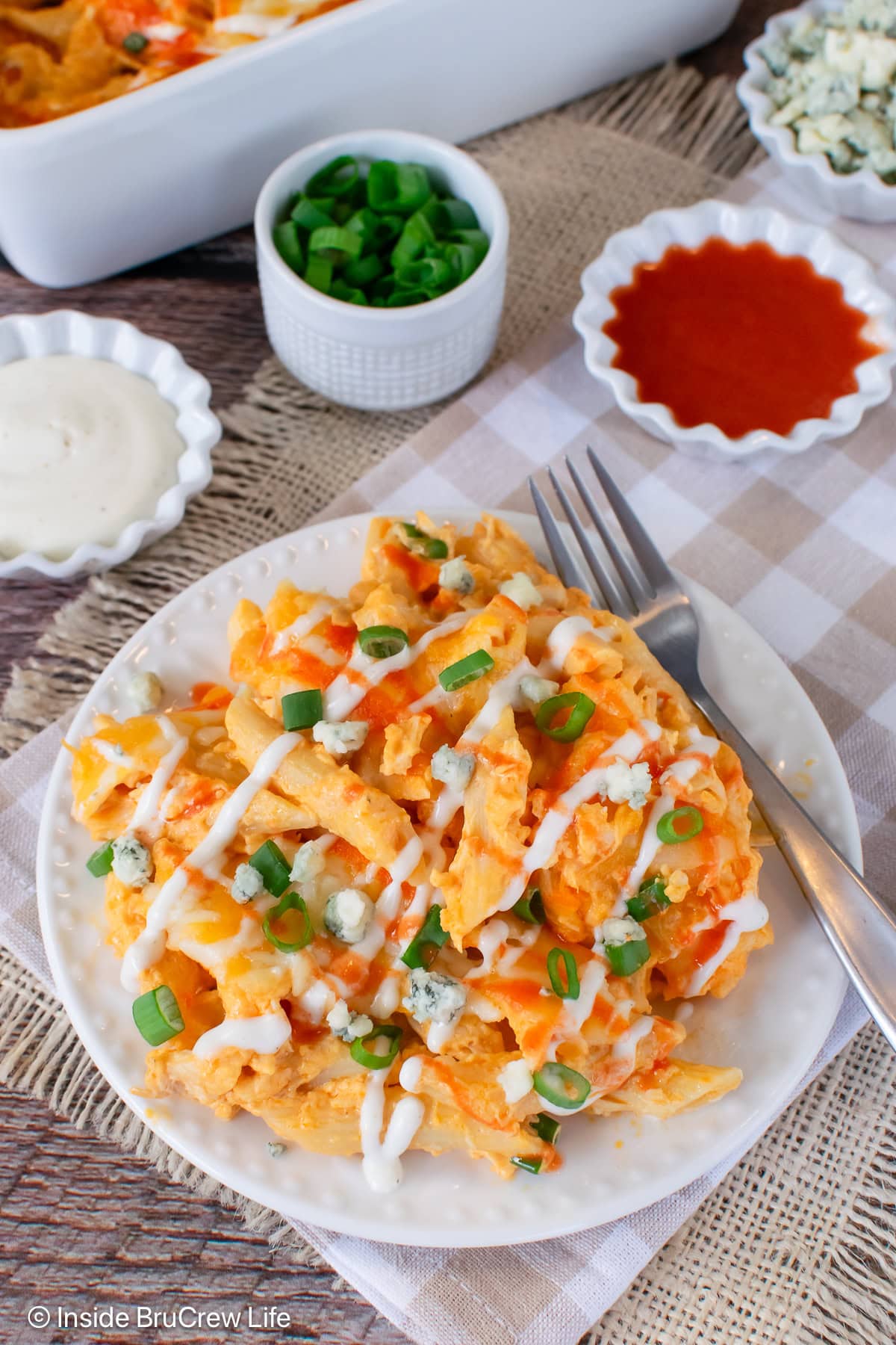 A serving of buffalo chicken pasta on a white plate.