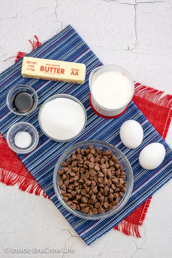 White board with bowls of ingredients to make a S'mores Pie.