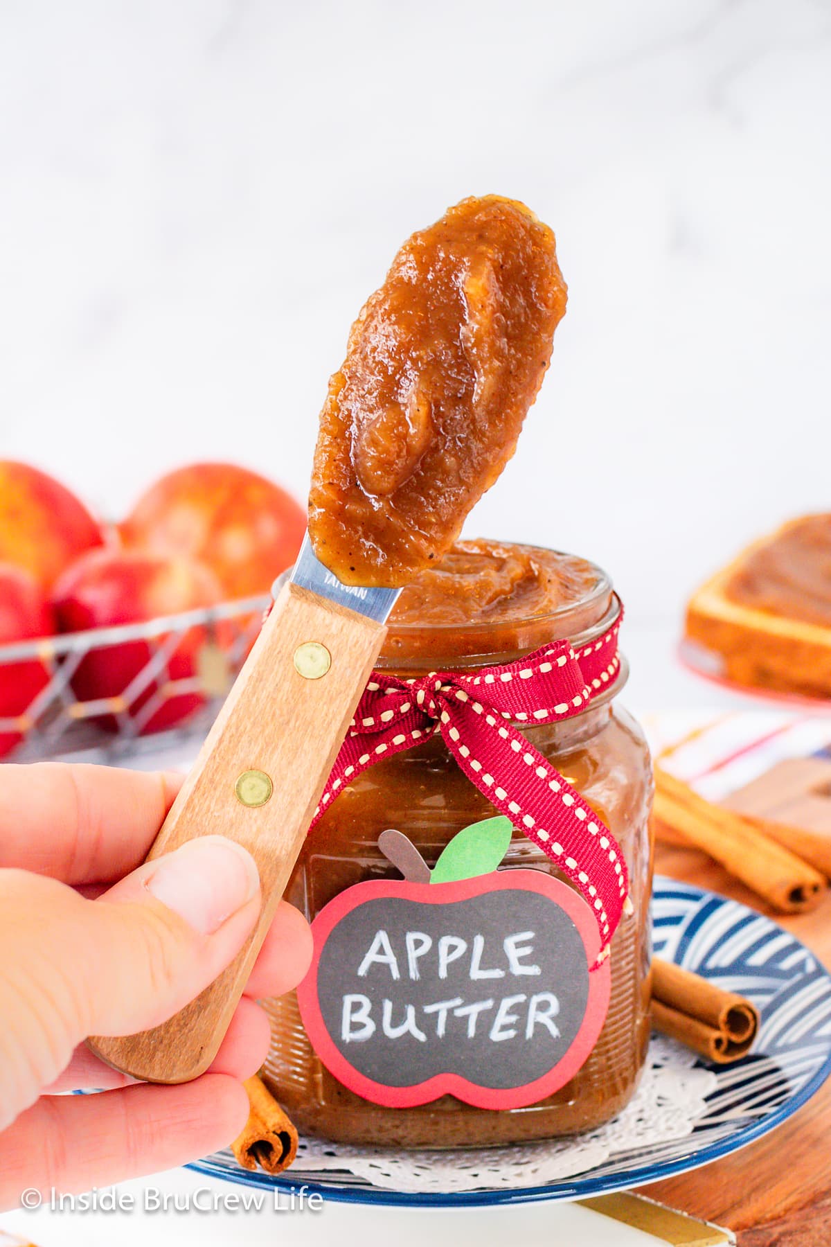 A spatula with apple butter on it.