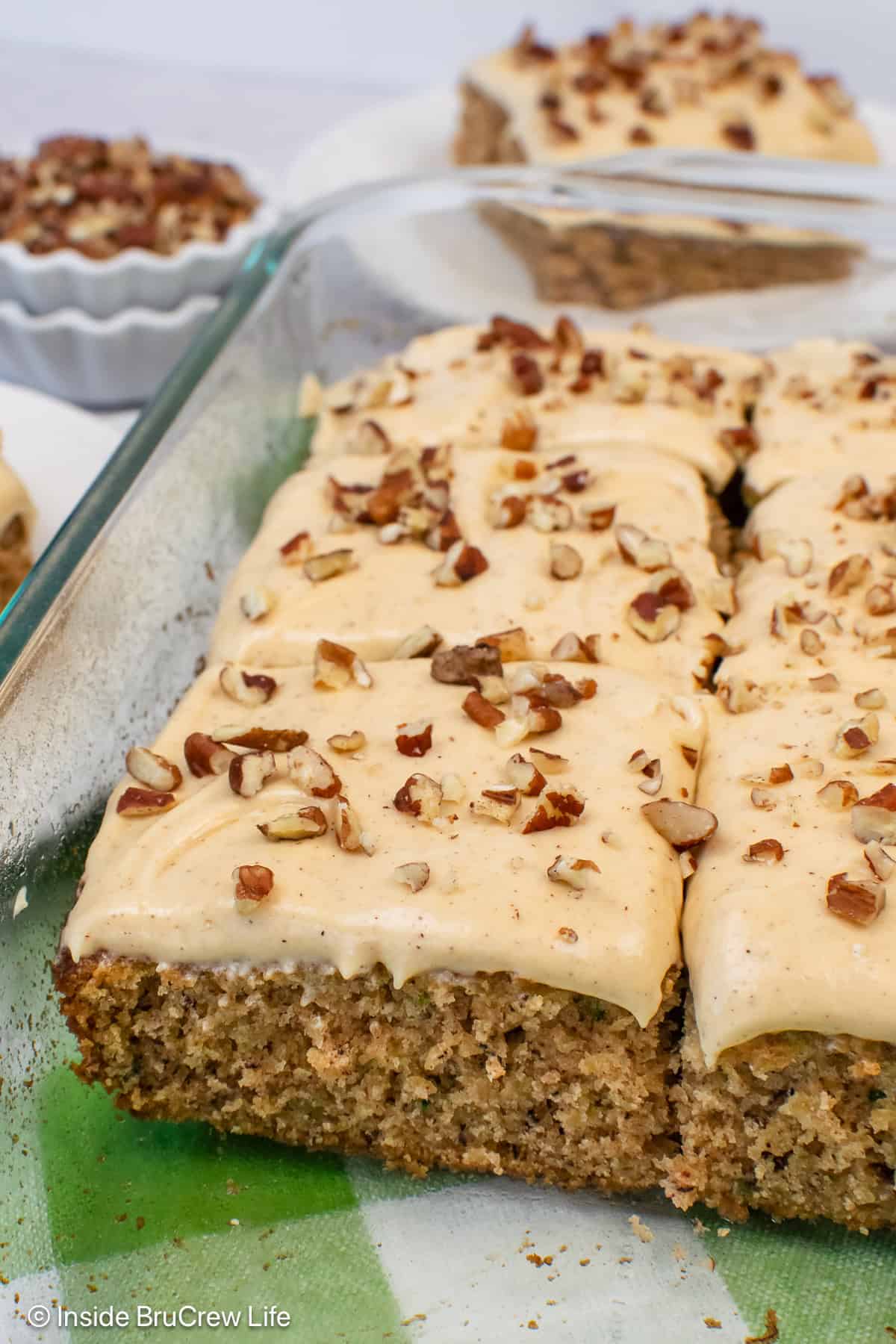 A pan of frosted banana zucchini cake.