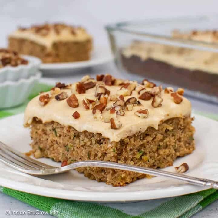 A square of banana zucchini cake on a white plate.