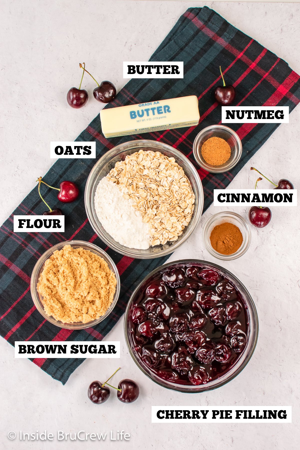 Bowls of ingredients needed to make a cherry dessert with oat topping.