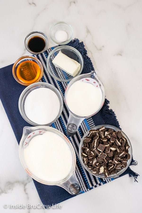 A white board with bowls of ingredients needed to make Oreo Ice Cream.