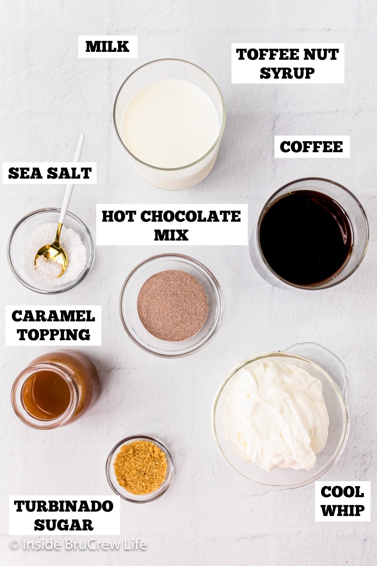 A white board with bowls of ingredients needed to make a latte with caramel.