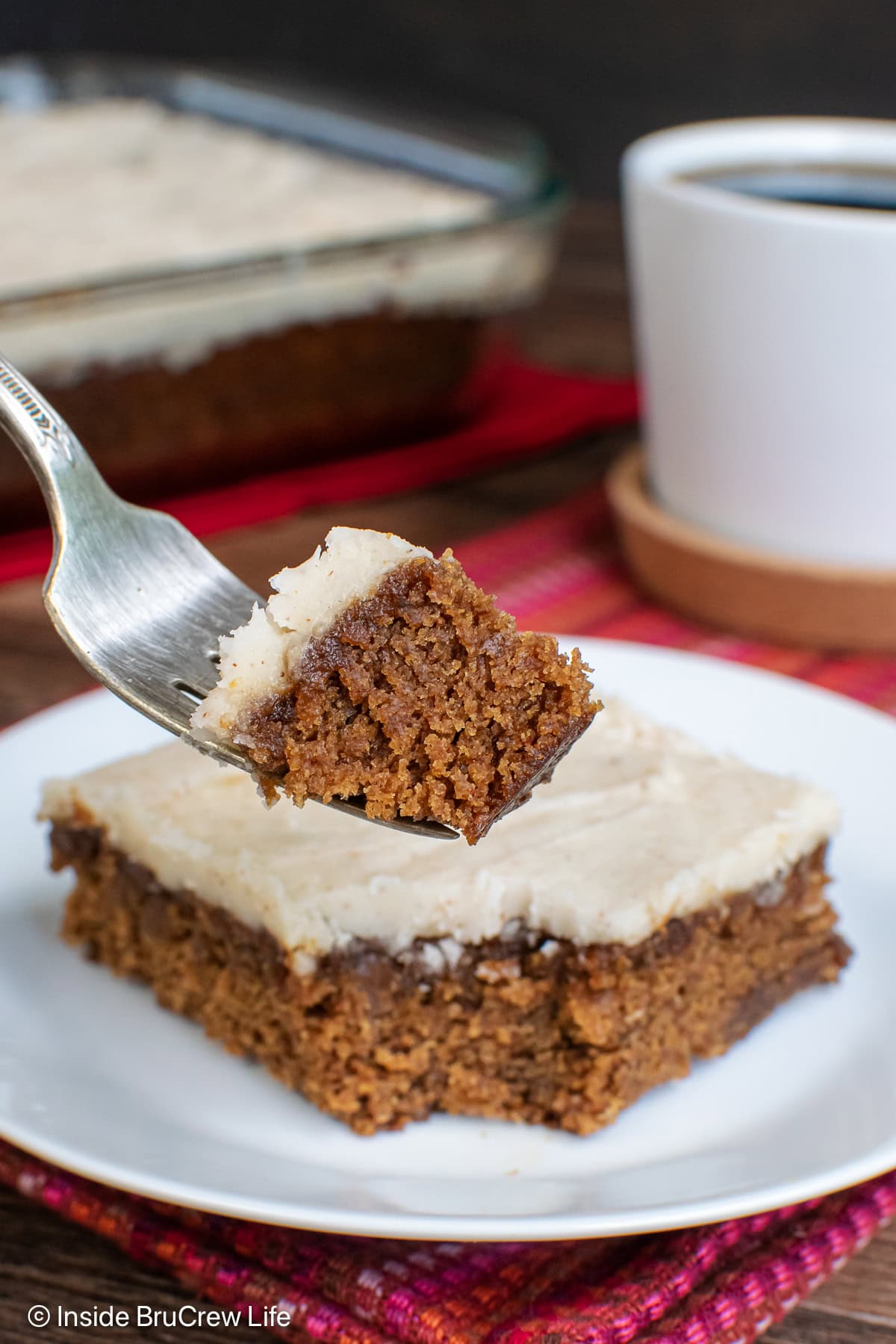 A fork with a bite of apple cake on it.