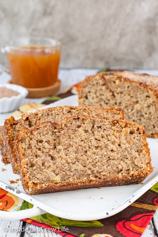 A white tray with slices of apple bread made with apple cider and cinnamon sugar.