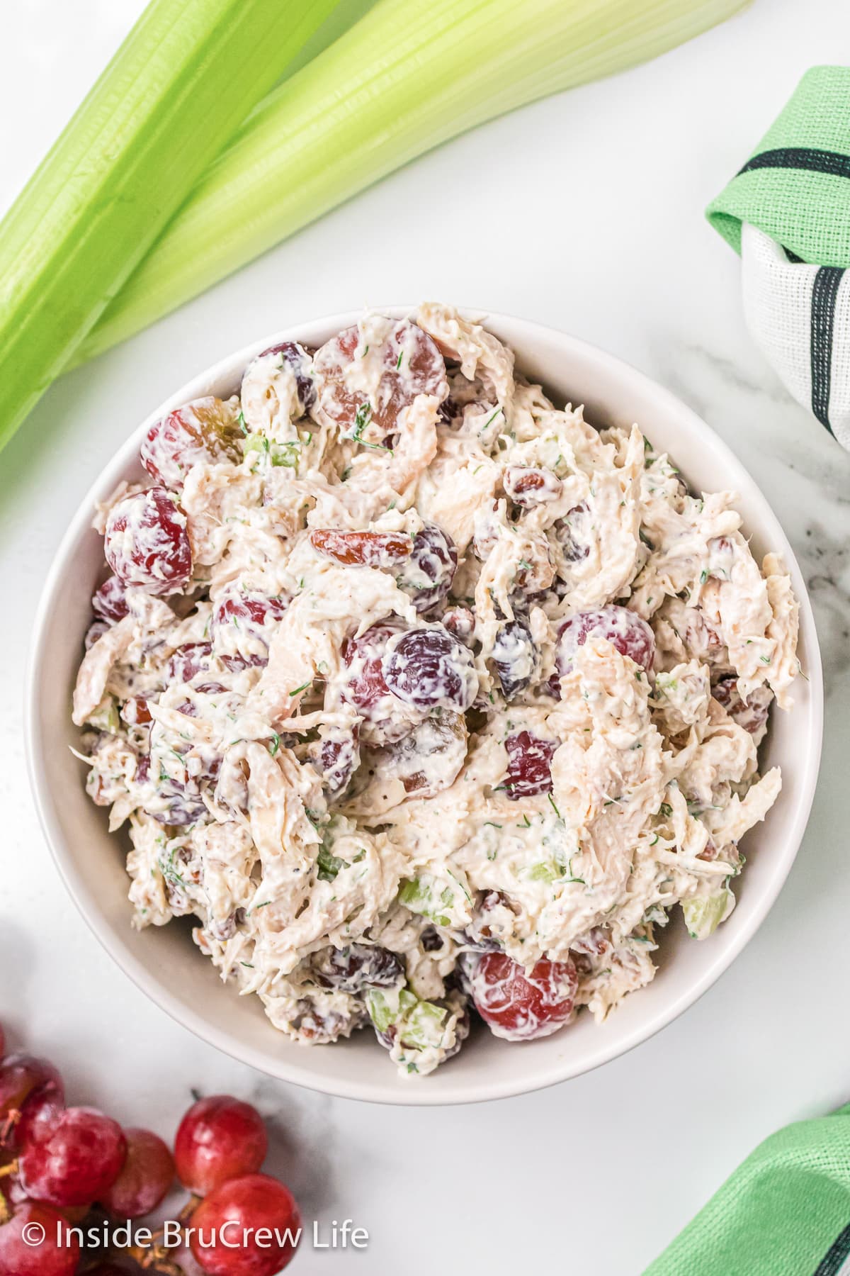 A white bowl filled with grape pecan chicken salad.