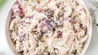 A white bowl filled with grape pecan chicken salad.