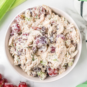 A white bowl filled with grape pecan chicken salad.
