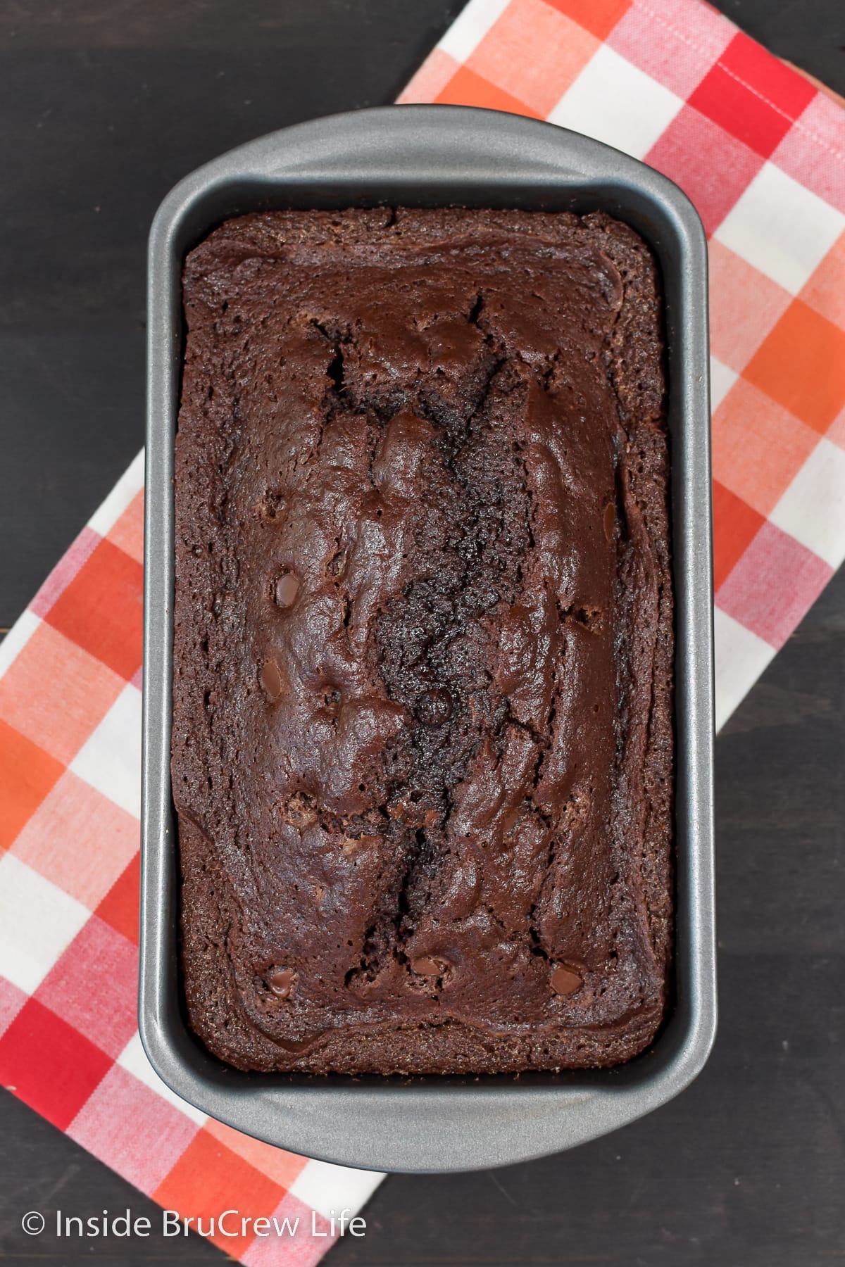 A loaf of chocolate bread on a board.