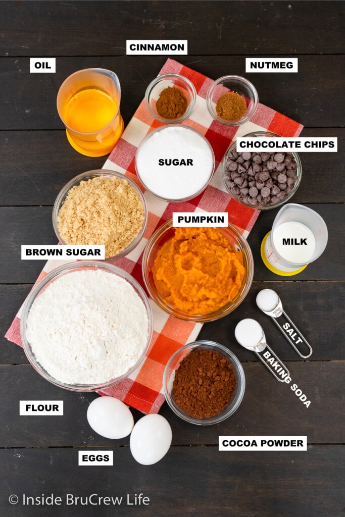 A board with bowls of ingredients needed for a pumpkin bread.