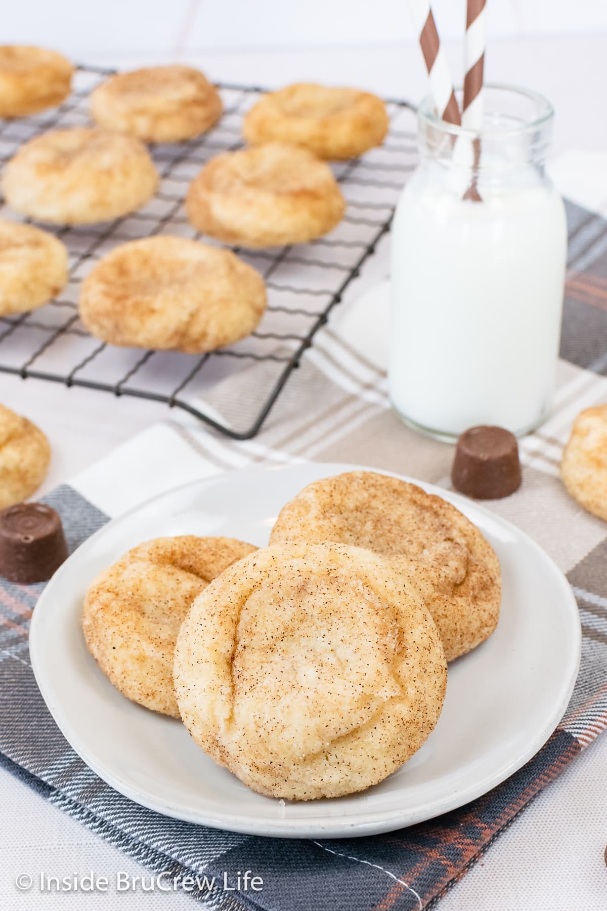 Three cinnamon sugar cookies on a white plate.