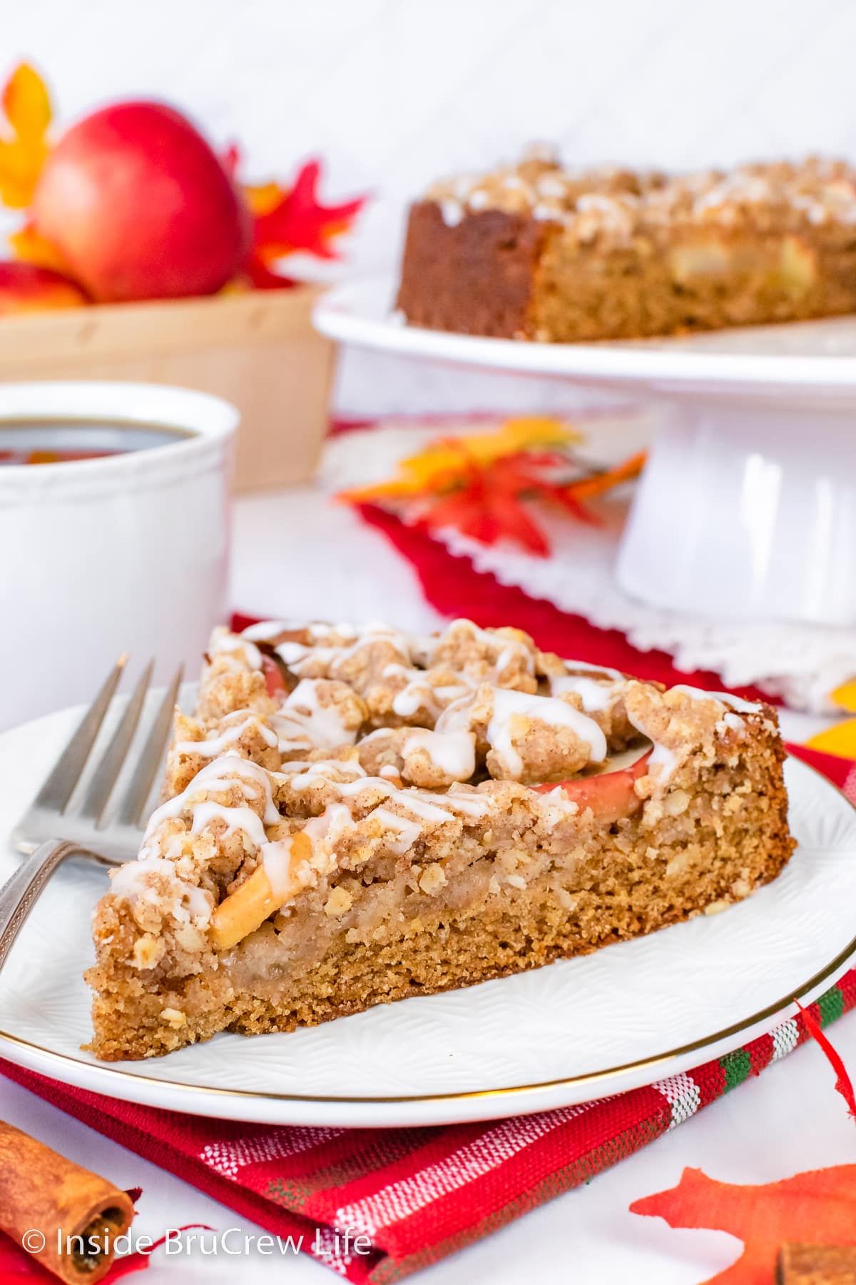 A slice of apple cake on a white plate.