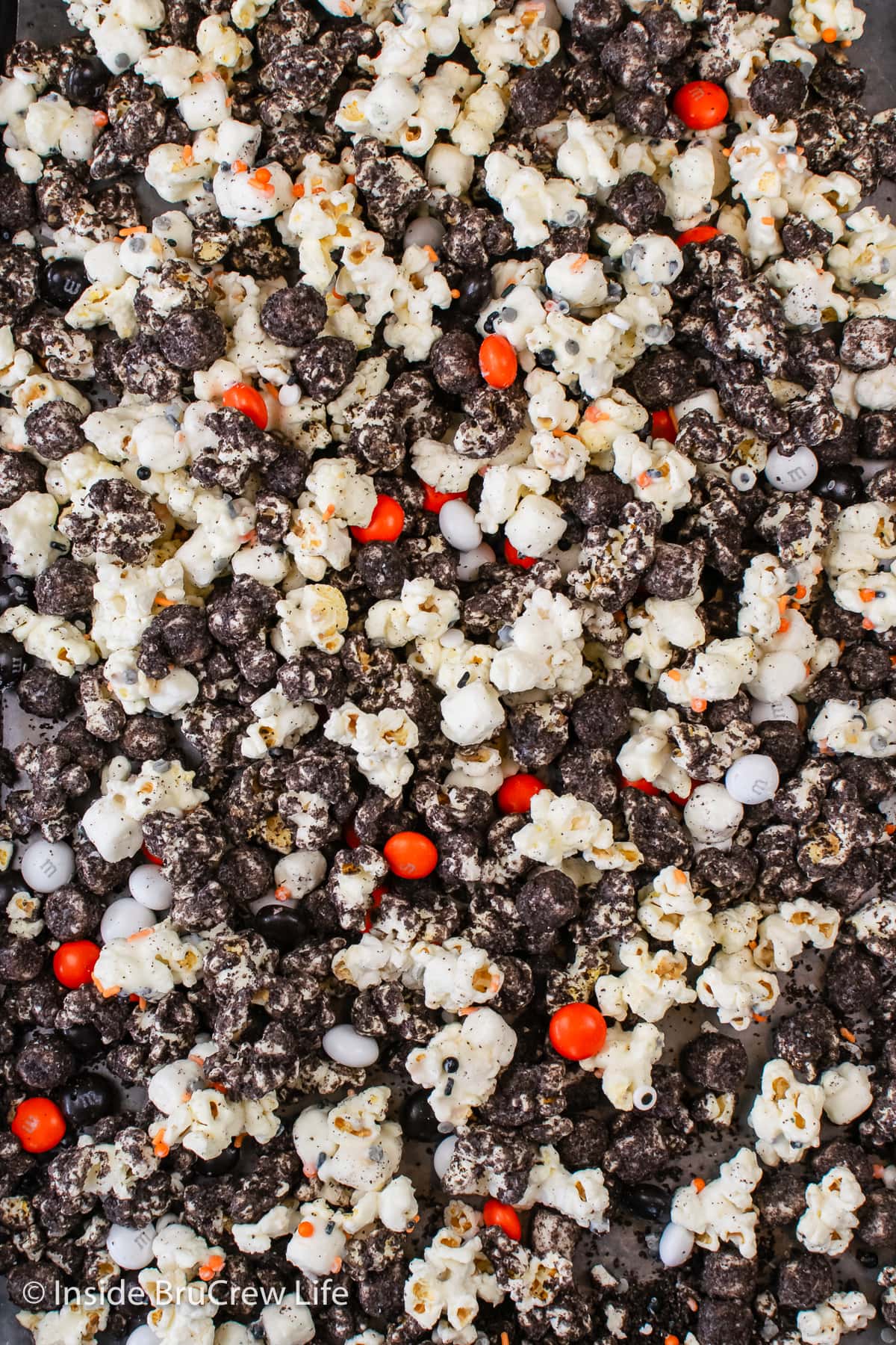 A sheet pan filled with white chocolate and Oreo popcorn.