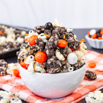 A white bowl filled with chocolate covered Oreo popcorn.