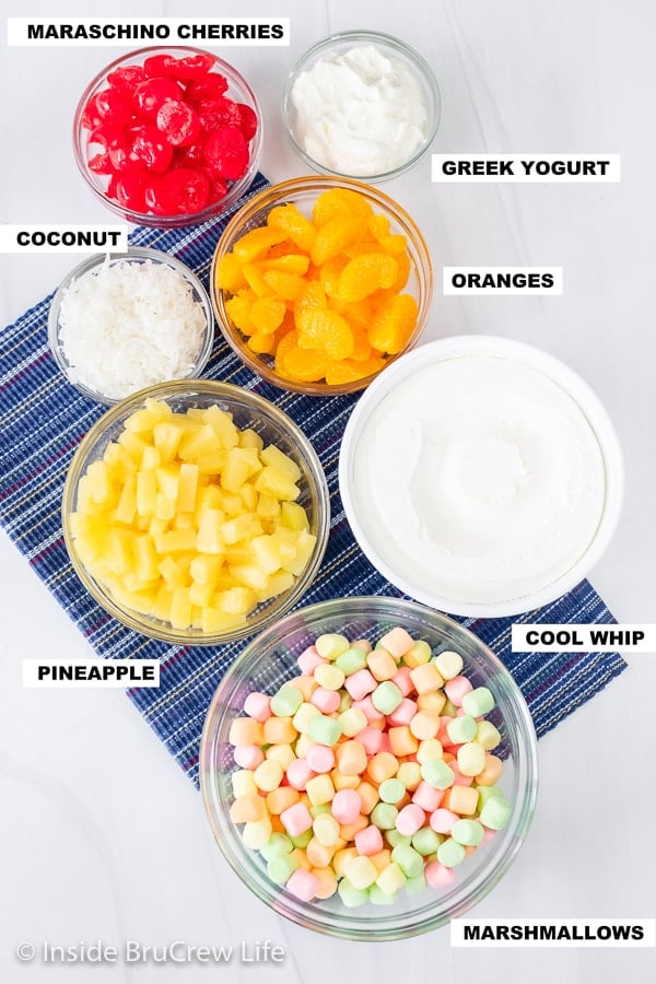 Overhead picture of a white board with bowls of ingredients needed to make an easy Ambrosia salad.