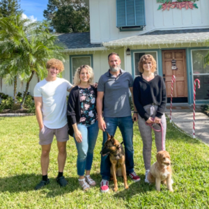 The Inside BruCrew Life family and their dogs in front of their house.