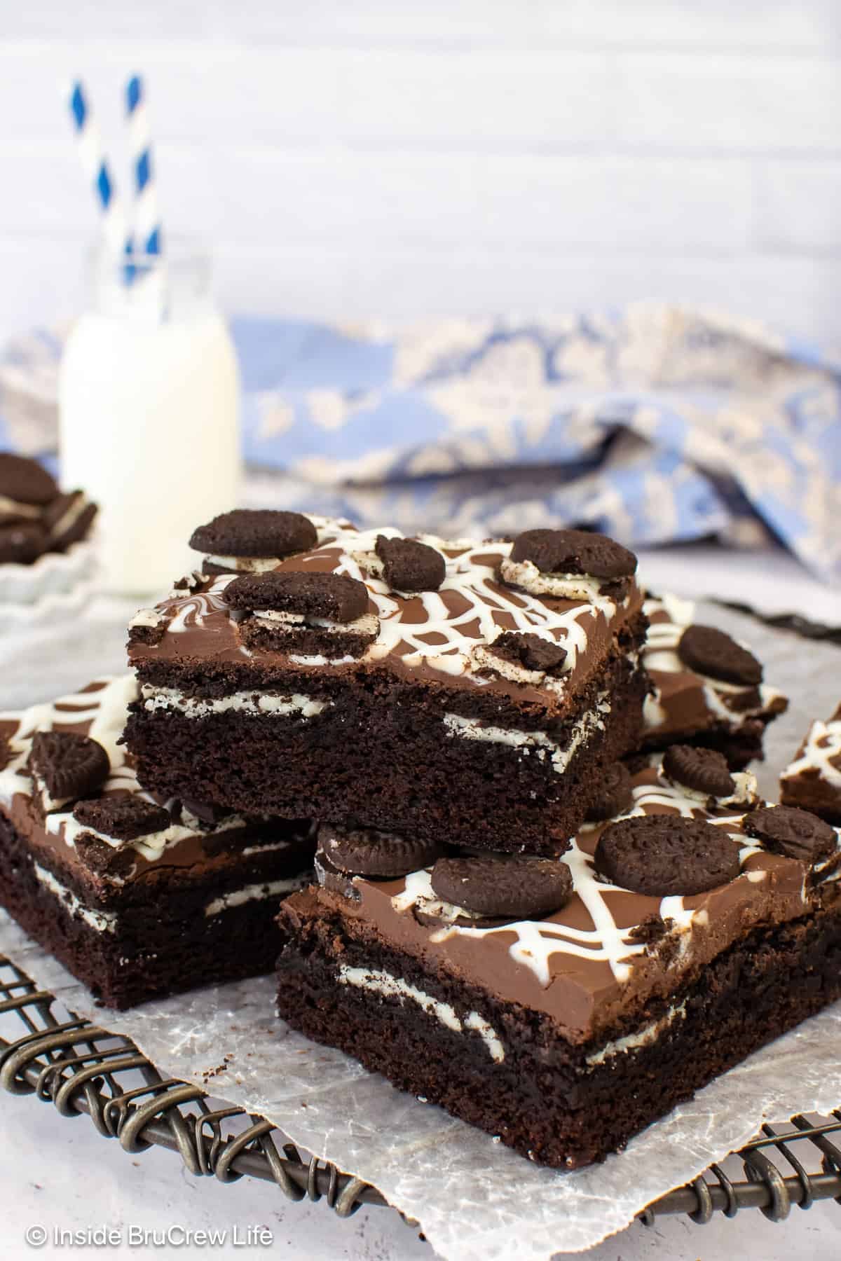 Oreo stuffed brownies in a pile on a plate.