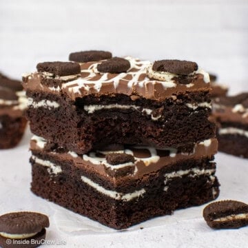 Two stuffed Oreo brownies with a bite out of the top one.