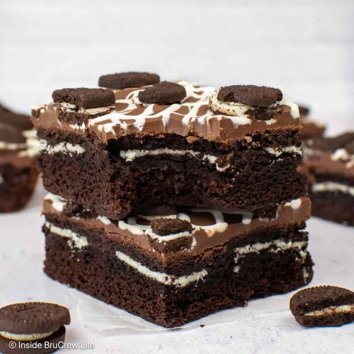 Two stuffed Oreo brownies with a bite out of the top one.